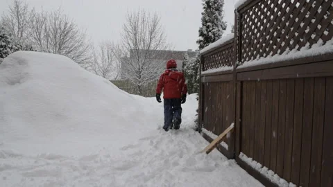 Boy walking on a snowy day back view Stock Footage 149456054