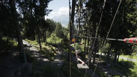 Boy walking through ropes course Stock Footage 148175484