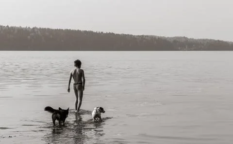 Boy walking in the water Stock Photos
