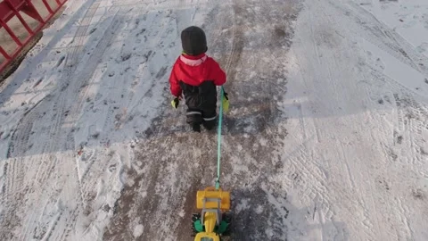 Boy Walking On A Winter Street Stock Footage 168984059