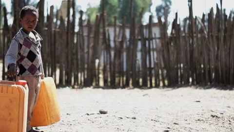 Boy walking with yellow canister Vidéo 137154745