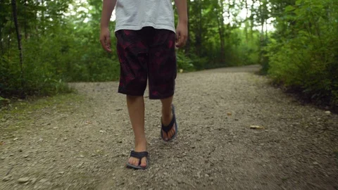 A boy walks alone on a trail in the forest Video stock 121553947