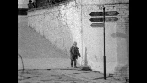 A boy walks along a high wall. shooting a rare movie camera. Stock-Footage 123235791