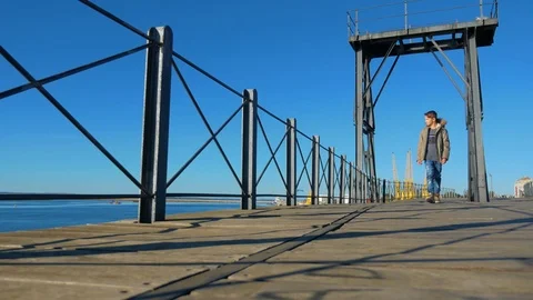 The boy walks along the pier Stock Footage 83683182
