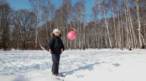 Boy walks and plays with a balloon with propeller Stock Footage