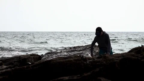 A boy walks on the beach Stock Footage 94408075
