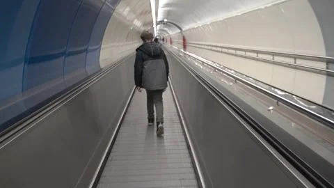 The boy walks down the escalator in the subway. Breathable Live Camera Video stock 251159056