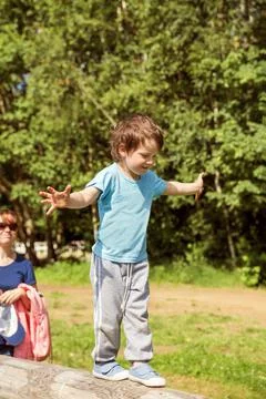 Boy walks on a log Stock Photos