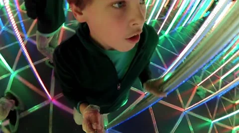 Boy walks in mirrored complex maze with Illumination, action camera Stock Footage 64209802