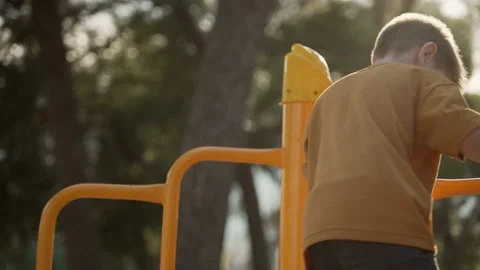 The boy walks in the park on the playground Video stock 203872624