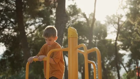 The boy walks in the park on the playground Video stock 203872631