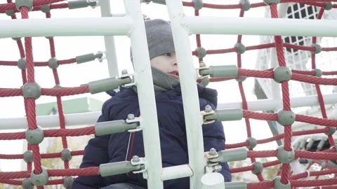A boy walks on a playground Vídeos de archivo 141253943