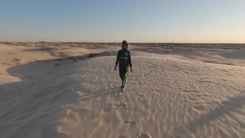 Boy walks on sand dunes Stock Footage 232554341