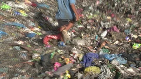Boy walks through garbage dump close-up on feet Stock Footage 48333894