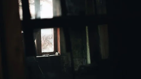 A boy walks through a room in an abandoned building Stock Footage 128016563