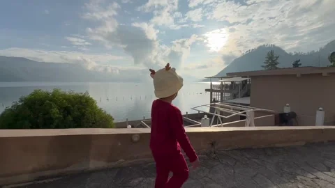 A boy walks under the view of the rising sun 動画素材 263852458