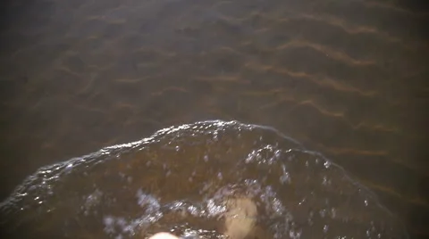 Boy walks on water at sunset Stock Footage 66350194