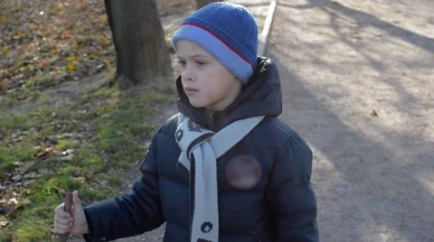 Boy in warm clothes walks in the Park Stock Footage 56820526