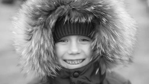 A boy in a warm winter jacket Stockbeeldmateriaal 82837613