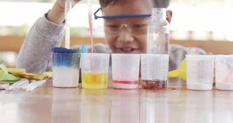 Boy was excited after dropping the mixture in crucible . Stock Footage 169122602