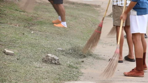 The boy was sweeping grass clippings Stock Footage 54451076
