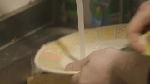Boy wash the dishes Video stock 304347459
