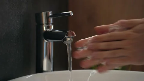 Boy washes his hands carefully, using soap and water Stock Footage 158055338