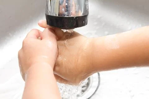Boy washes his hands Stock Photos