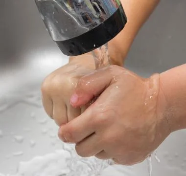 Boy washes his hands Stock Photos