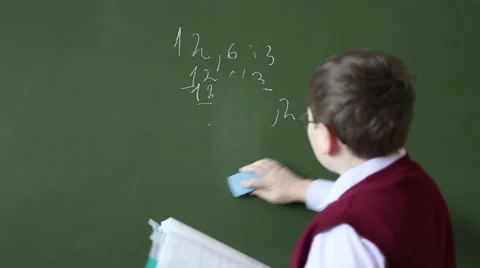 Boy washes with the school board and begins to solve example Stock Footage 58867027