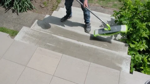 A boy washes the steps of the house Stock Footage 228857320