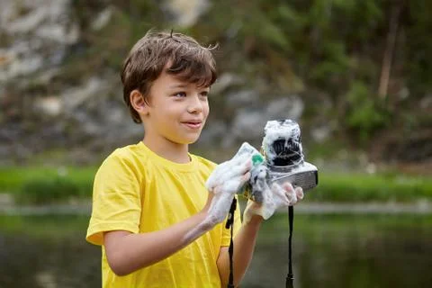 Boy is washing digital camera. Foto stock