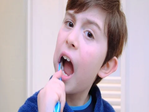 Boy washing his teeth Stock Footage 72894660