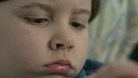 Boy watch cartoon on the phone while parents is busy. close up Video stock 130670735