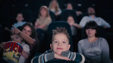 The boy watch the movie in a cinema Stock Footage
