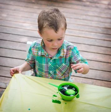 Boy Watches His Easter Egg in the Green Dye Stock Photos