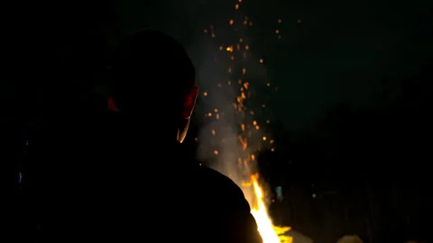 Boy watching a campfire Stock Footage 240567295