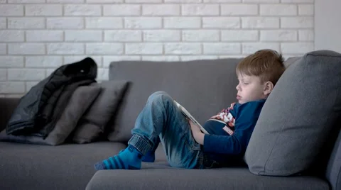 Boy Watching Cartoons on a Tablet Computer, Side View Stock Footage 62521568
