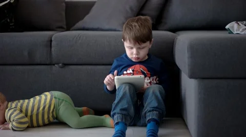 Boy Watching Cartoons on a Tablet Computer Stock Footage 62521728