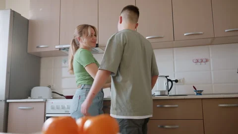 Boy Watching Mom Returning Item to Cabinet in Kitchen Stock Footage 321099692