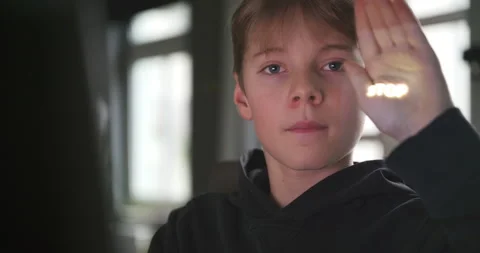 Boy watching something on a computer and showing a stop sign Stock Footage 234606962