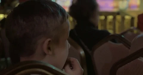 Boy watching theatrical performance and applauding Stock Footage 80043803
