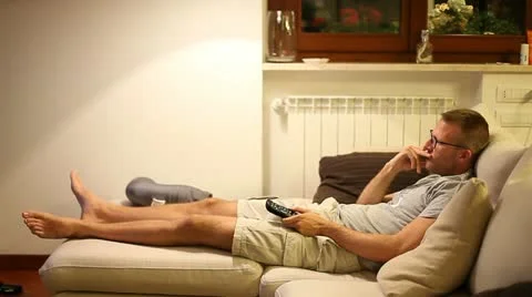 A boy watching tv on sofa Stock Footage 11236479