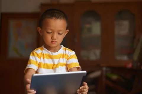 Boy watching video on computer 写真素材