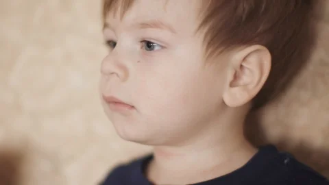 Boy watching a video on sofa Vídeos de archivo 126174134