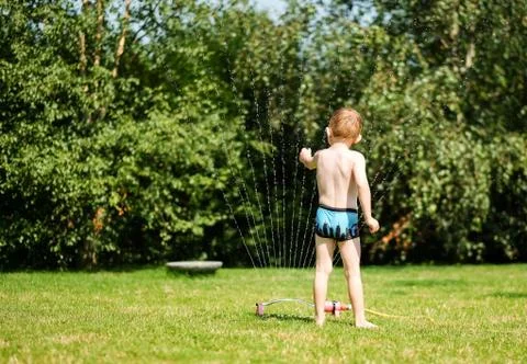 Boy with water sprayer Stock Photos