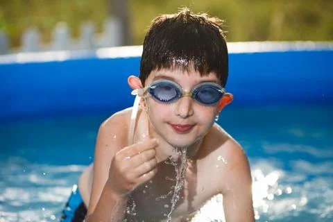 Boy in water with thumbs Stock Photos