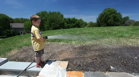 Boy watering soil Video stock 7747568