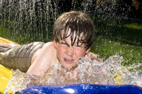 Boy on waterslide Stock Photos