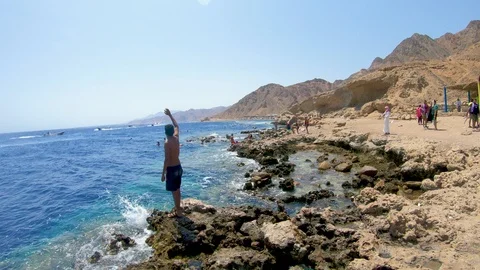 Boy waving goodbye to the beach Stock Footage 116735629